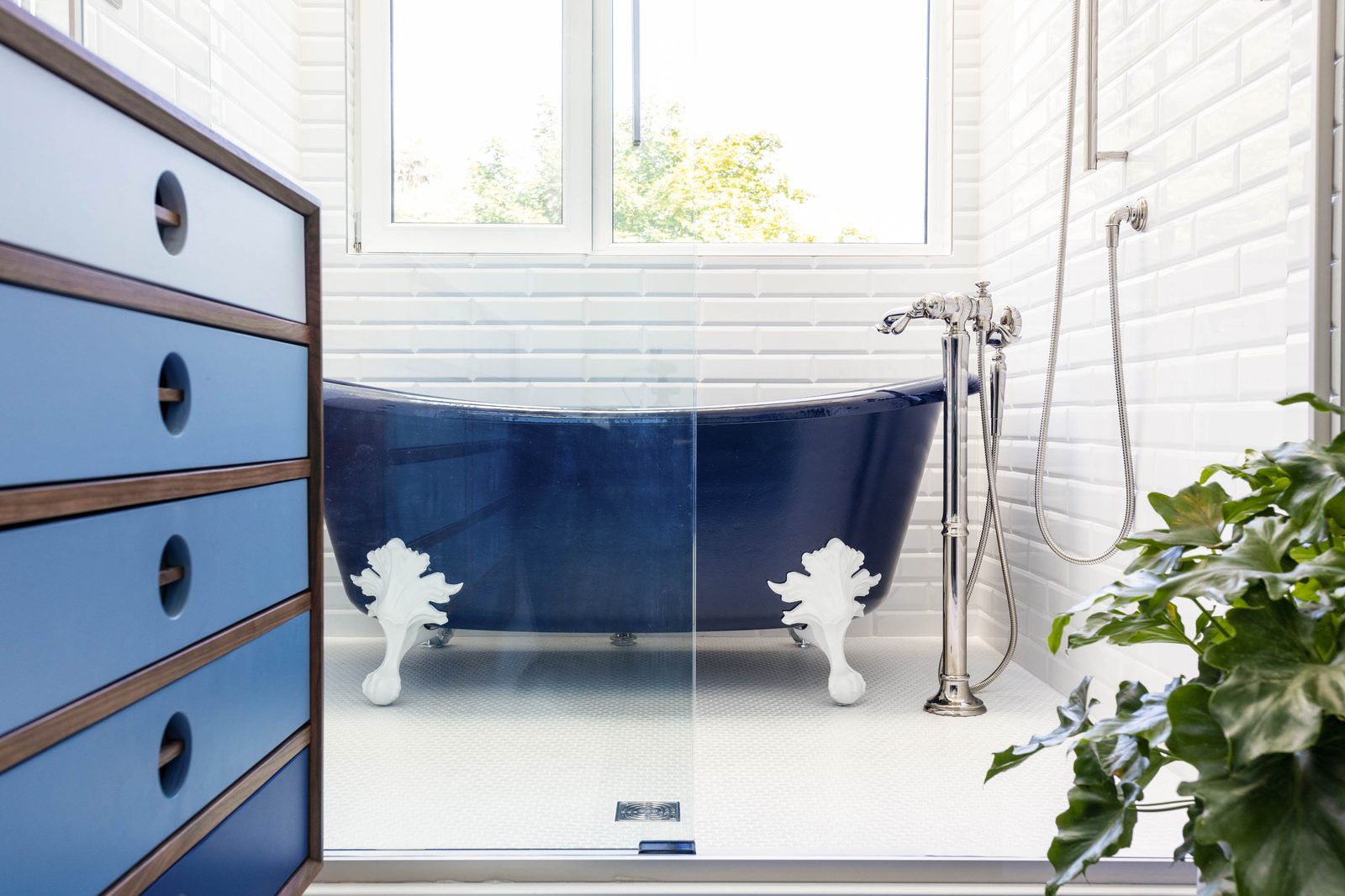 Editorial interior photograph of a main bathroom with a freestanding tub viewed from the vanity, showing the kind of clean, transparent quality designers expect when hiring an editorial-grade interior photographer.