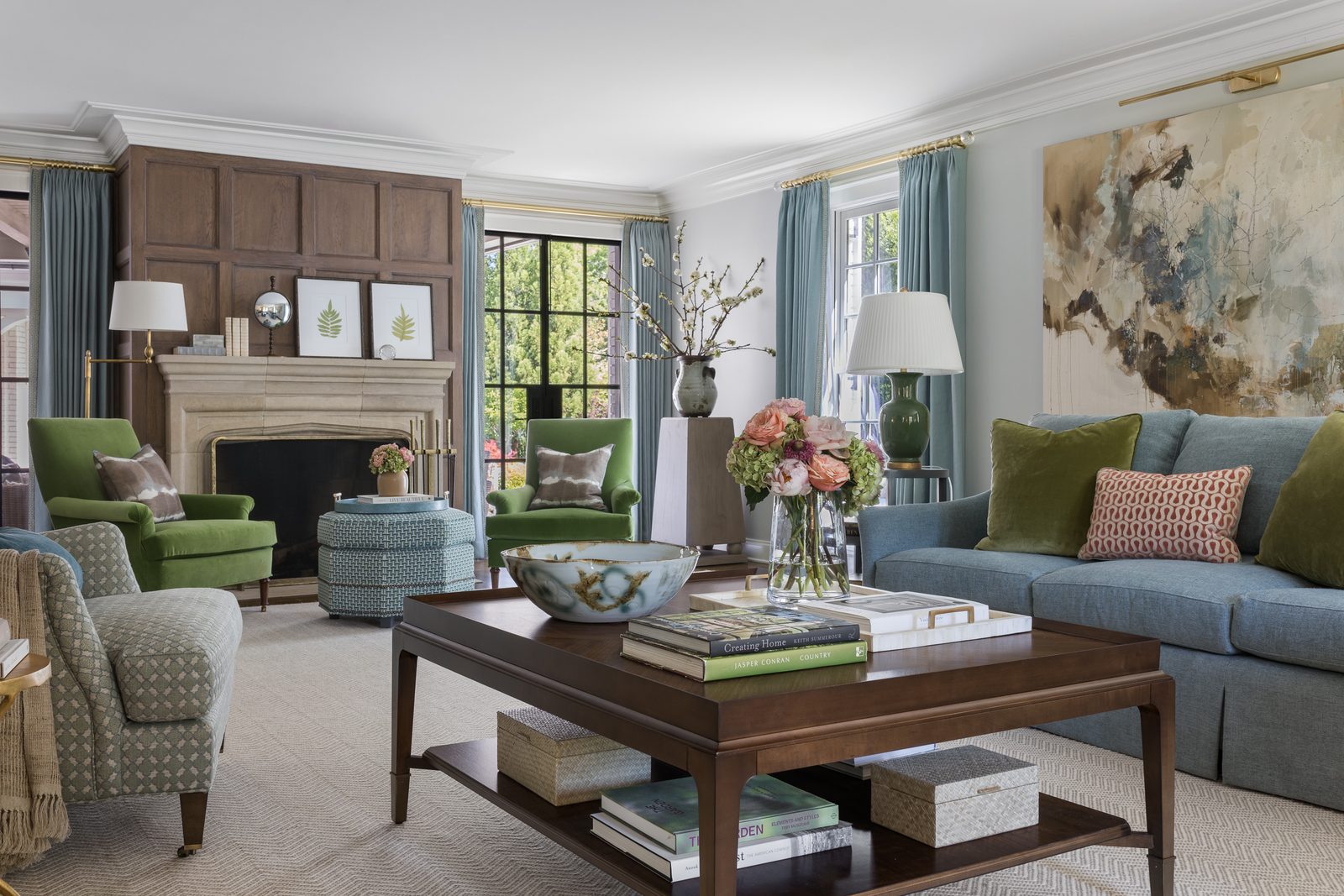 Layered traditional living room with green armchairs, a blue sofa, and large-scale art — a final frame agreed on set, locked into the delivery before leaving the shoot.