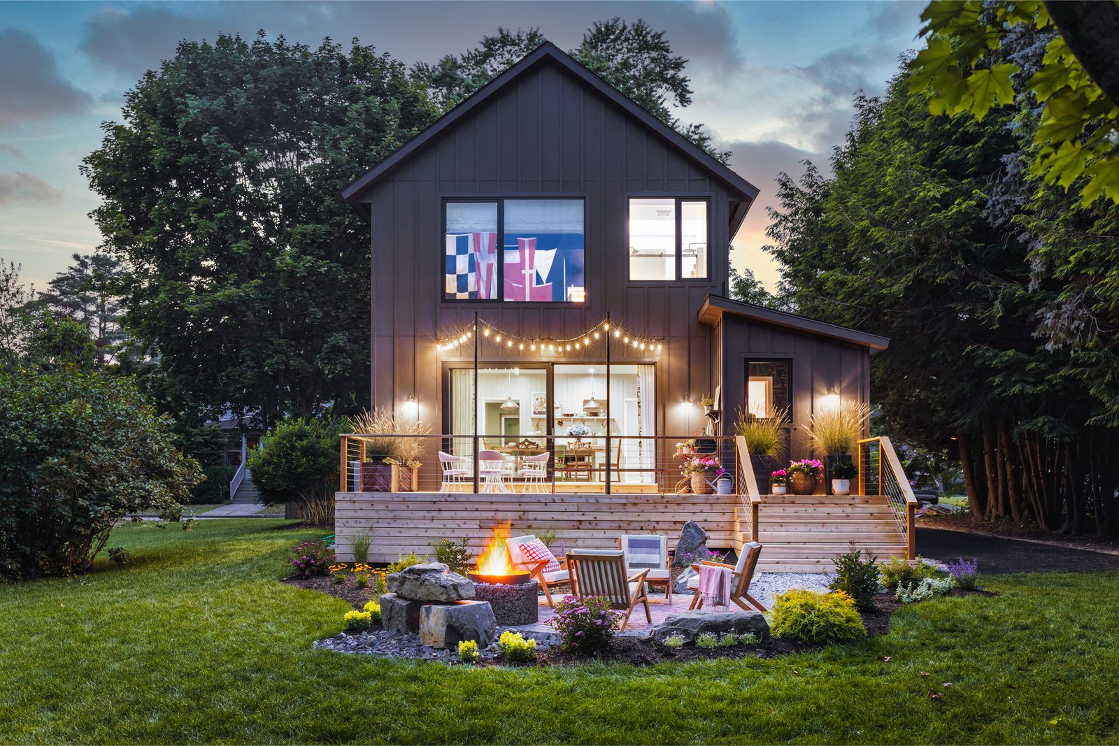 Evening exterior photograph of a residential backyard with landscape lighting on, taken on a Southern travel-day interior photography shoot outside Atlanta.